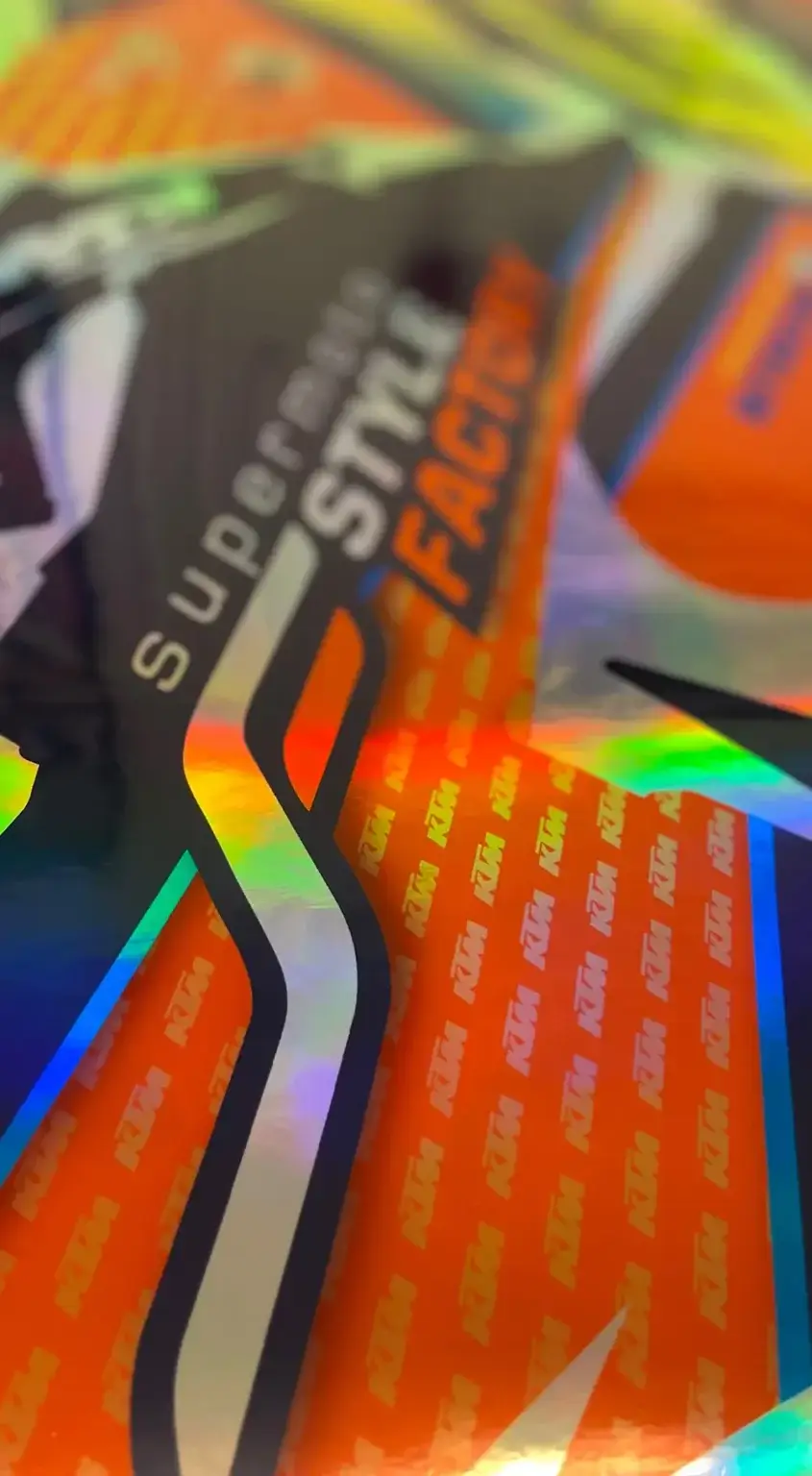 A KTM Supermoto graphic with a shiny holographic style in orange and black.