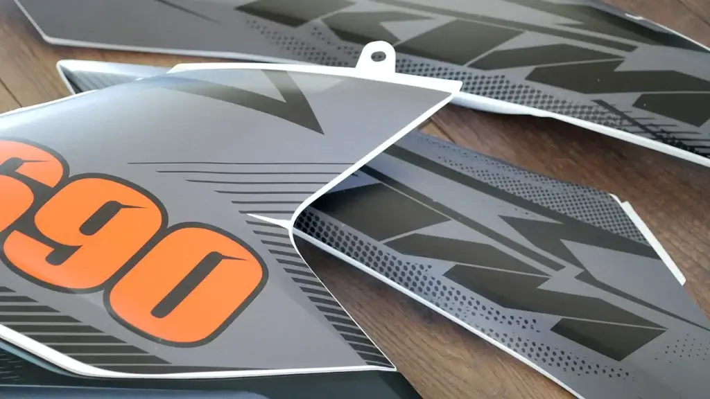 KTM fairing parts with matte grey and orange graphics.