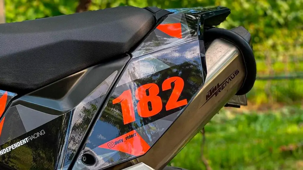 Motorcycle side panel with custom graphic kit with number 182 and Instagram Name.