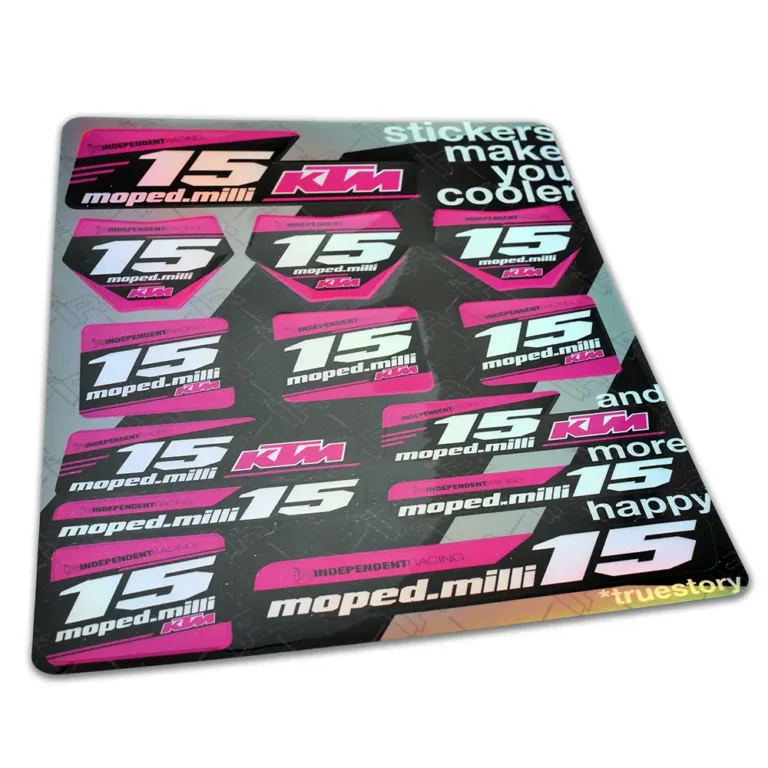 A pink and black sticker sheet featuring KTM branding and a sporty design with a holographic finish.