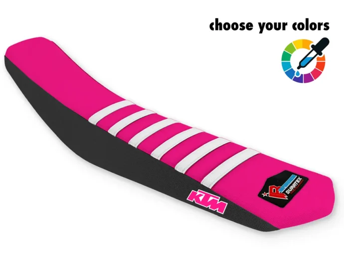 Pinker KTM Sitzbankbezug für Motocross, Enduro & Supermoto mit weißen Rippen, schwarzen Seiten und KTM-Logo.