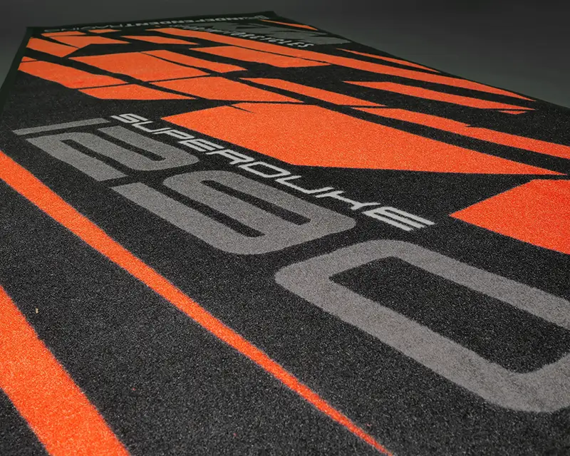 Black and orange KTM pit mat with large “1290 Superduke” lettering.